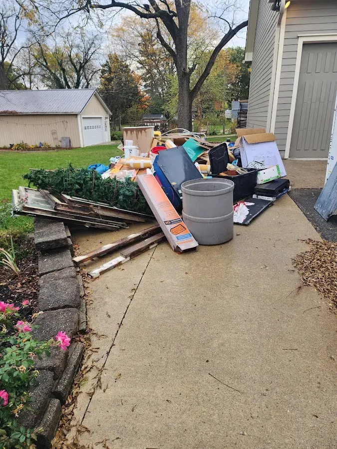 Dumpster being loaded with debris for 3 Yard Dumpster Rental in St. Anthony